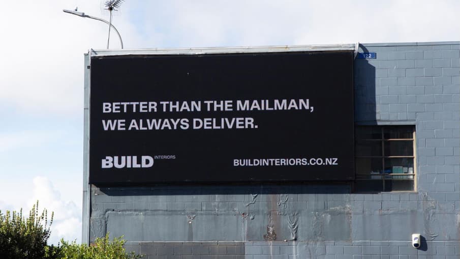 Billboard with writing "Better than the mailman, we always deliver."